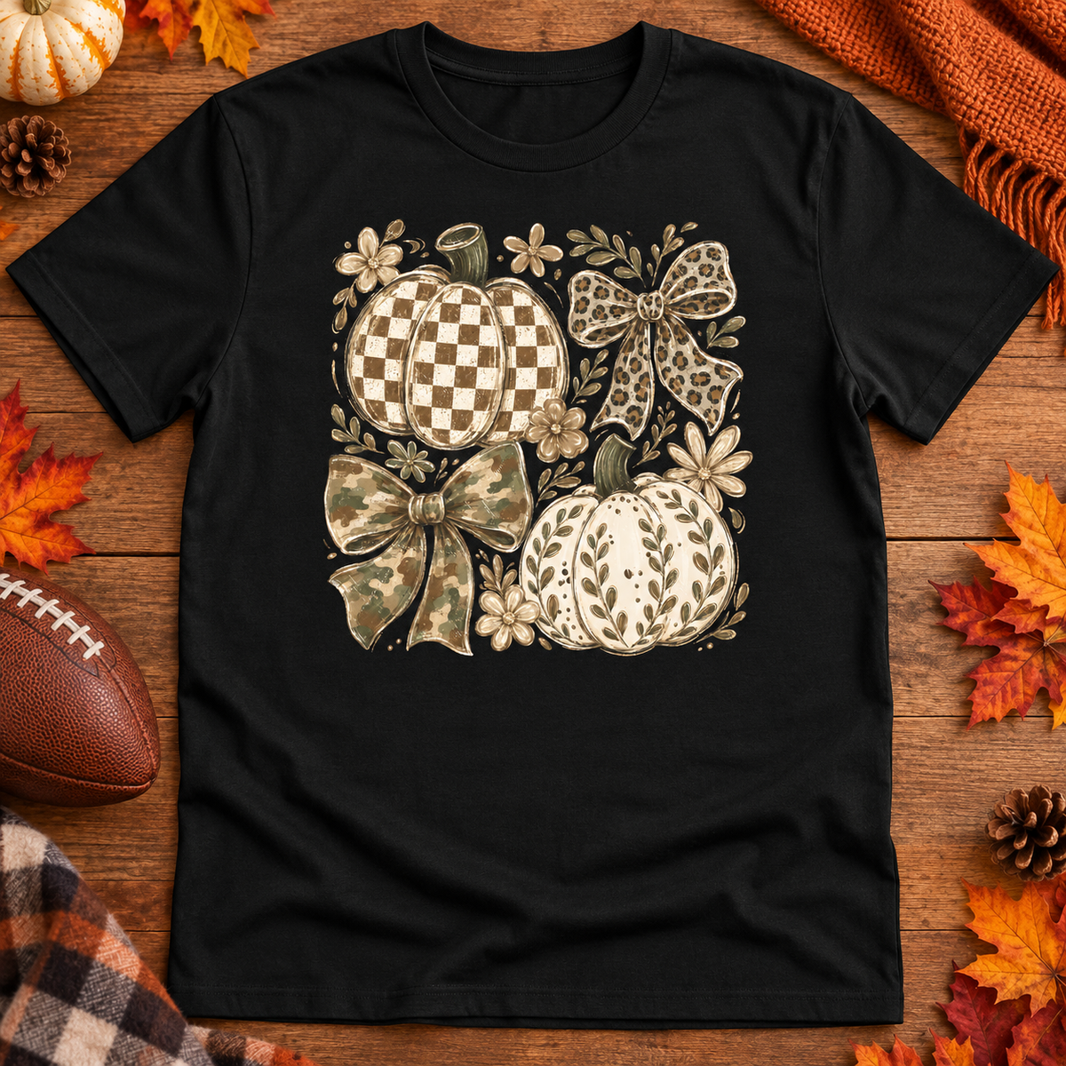 Neutral checkered pumpkins and patterned bows on a black adult shirt