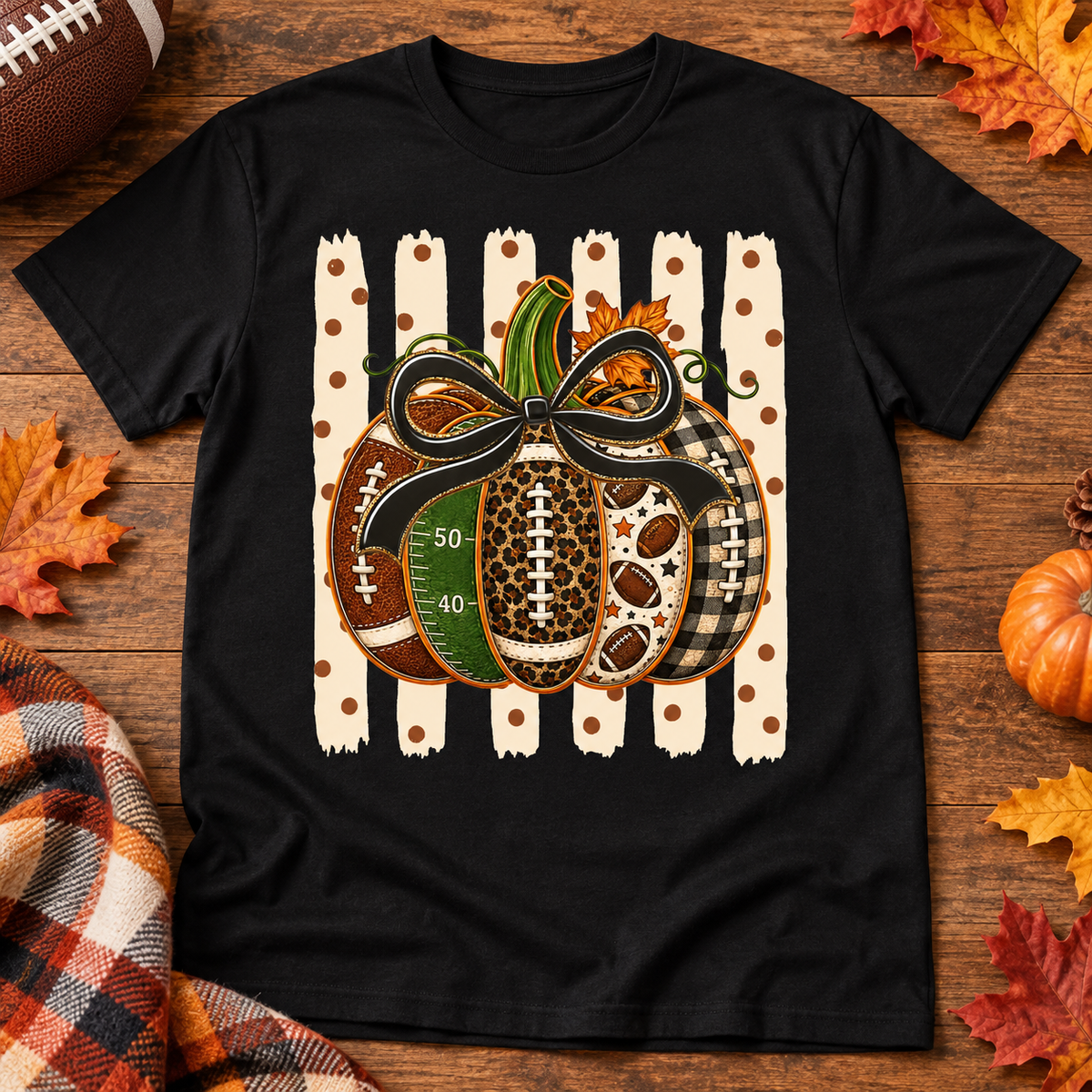 Football patterned pumpkin with black bow on a black adult shirt